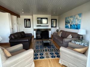 a living room with two couches and a fireplace at Firm Anchor in Salcombe
