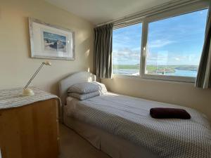 a small bedroom with a bed and a window at Firm Anchor in Salcombe