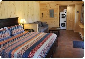a bedroom with a bed and a couch in a room at Mountain View Cottage in Wilmington