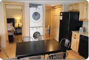 a kitchen with a black table and a black refrigerator at Mountain View Cottage in Wilmington
