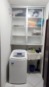 a refrigerator with its door open in a kitchen at Apt Vista para o Mar in Conde