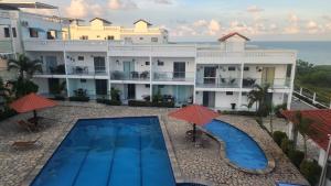 an aerial view of a hotel with a swimming pool at Apt Vista para o Mar in Conde +4 photos