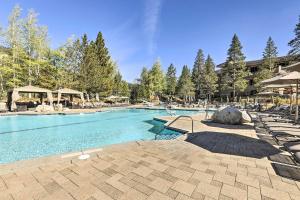 a large swimming pool with chairs and umbrellas at Everline Resort Studio w/ Luxury Resort Perks in Olympic Valley