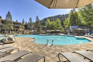 a large swimming pool with chairs and a resort at Everline Resort Studio w/ Luxury Resort Perks in Olympic Valley