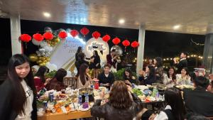 a group of people sitting at tables at a party at Pine Hill Villa 3 Vì in Ba Vì +109 photos