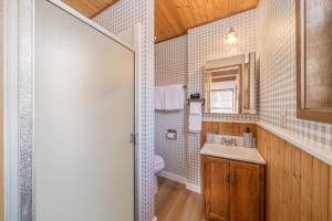 a bathroom with a toilet and a sink at After Dune Delight MCA#50643 in Manzanita +36 photos