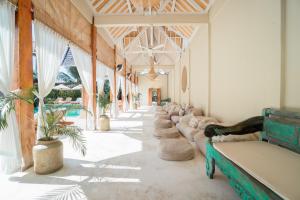 a hallway with a row of couches in a building at Rascals Hotel - Adults Only in Kuta Lombok