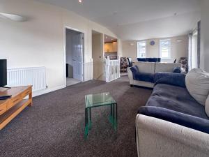 a living room with a couch and a table at Royal Retreat in Wisbech