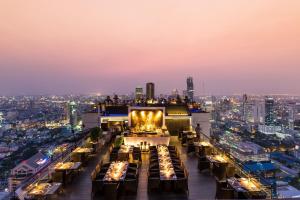 a restaurant on the roof of a building with a city skyline at Banyan Tree Bangkok - SHA Extra Plus Certified in Bangkok