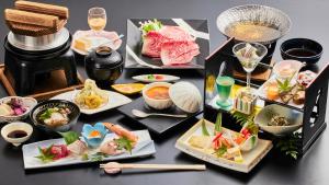 a table topped with different types of food on plates at 霧島花紫 in Kirishima