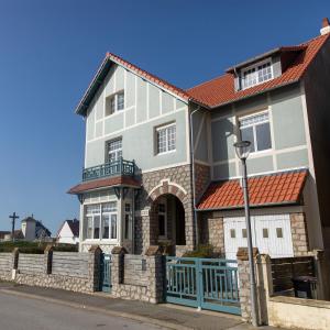 a large white house with an orange roof at La Villa L'Escale - B&B vue mer à Audresselles in Audresselles