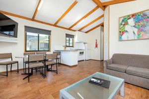 a living room with a couch and a table at All Seasons Mildura Holiday Park in Mildura