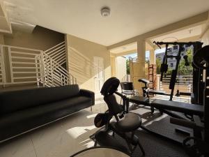 a living room with a gym with tread machines at 1 BR Love Cube in Kingston