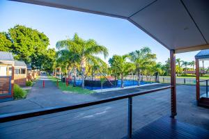a view of a playground with palm trees and a building at All Seasons Mildura Holiday Park in Mildura