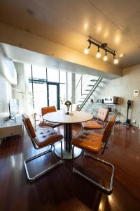 a dining room with a table and chairs at ARTK'SJosui in Fukuoka