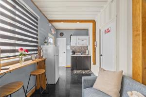 a kitchen and a living room with a couch and a refrigerator at Cozy 1BR Beachside Apartment Entre Olas in Vega Baja