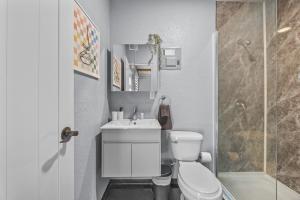 a bathroom with a toilet and a sink and a shower at Cozy 1BR Beachside Apartment Entre Olas in Vega Baja +15 photos