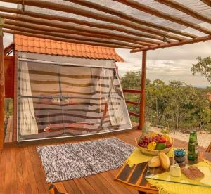 a table with a bowl of fruit on a deck at Glampiri in Pirenópolis