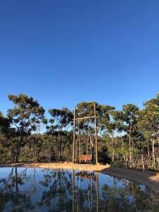 a bench sitting in the middle of a body of water at Glampiri in Pirenópolis +2 photos