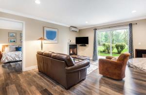 a living room with a couch and a bed at First-Floor Downtown Bend Condo in Bend