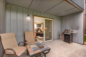 a patio with chairs and a table and a grill at First-Floor Downtown Bend Condo in Bend