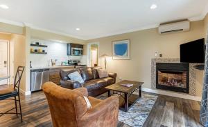 a living room with a couch and a fireplace at First-Floor Downtown Bend Condo in Bend
