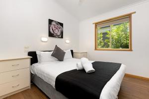 a bedroom with a large bed and a window at All Seasons Mildura Holiday Park in Mildura +62 photos