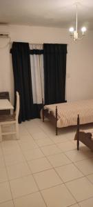 a bedroom with two beds and a window at Casa Sofía in Paraná