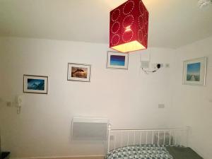 a red chandelier hanging over a bed in a room at Quick Stop Double Bed Flat - Bradford City Center in Bradford