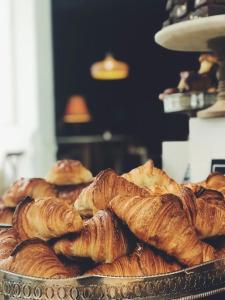 a bunch of croissants and pastries on a table at Pahalgam Resort and Cottages in Pahalgām