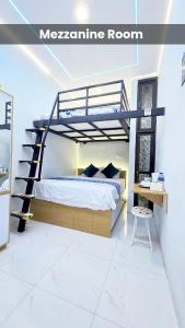a bedroom with a bunk bed and a staircase at Laswi Syariah Guest House in Bandung