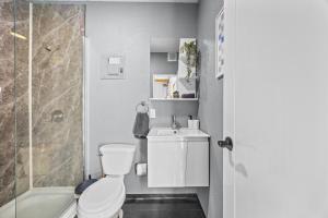 a bathroom with a toilet and a sink and a shower at Beachside 1BR Apartment Sleeps 4 in Vega Baja +9 photos