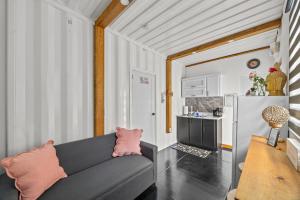 a living room with a couch and a kitchen at Beachside 1BR Apartment Sleeps 4 in Vega Baja