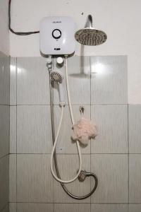 a shower in a bathroom with a shower head at Kon Tree Shade in Dambulla +58 photos