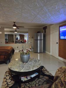 a living room with a vase on a table at Cozy Mobay in Hampton