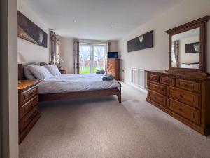 a bedroom with a bed and a large mirror at Royal Retreat in Wisbech
