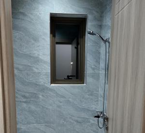 a bathroom with a glass shower with a mirror at O2P Al Salam in Medina +16 photos