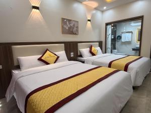 a hotel room with two beds in a room at Marina Cua Lo Hotel in Cửa Lô