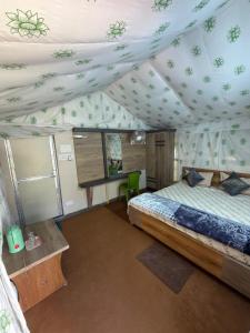 a bedroom with a bed in a tent at Palashbhumi Resort in Barhanti