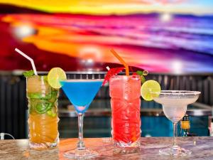 a group of three cocktails sitting on a table at Baan mae resort in Ban Takat Ngao