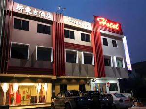 a hotel with cars parked in front of it at Swing & Pillows - Skudai Johor in Skudai