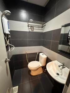 a bathroom with a toilet and a sink at Swing & Pillows - Skudai Johor in Skudai
