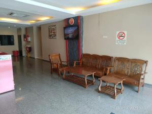 a waiting room with leather chairs and a tv at Swing & Pillows - Skudai Johor in Skudai +23 photos