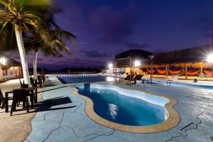 a resort with a swimming pool at night at Hotel Arena Beach Cartagena in Cartagena de Indias