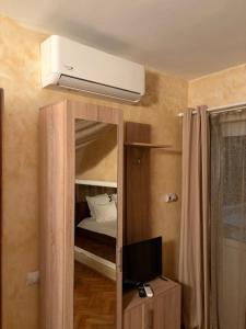 a room with a bedroom with a bed and a television at Casa Rania in Sibiu