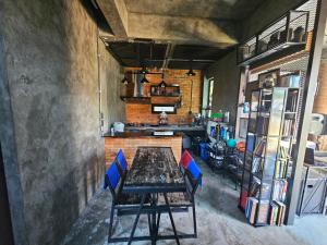 a dining room with a table and blue chairs at Navy Medic 36 Poolvilla in Sattahip