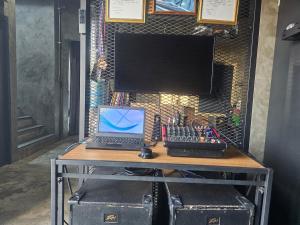 a desk with a laptop computer and a keyboard at Navy Medic 36 Poolvilla in Sattahip