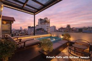 a rooftop patio with a swimming pool on a building at Minerva Premium Hotel in Hanoi