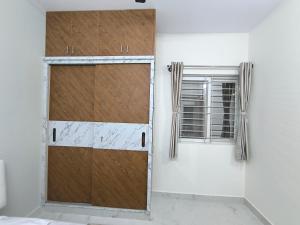 a sliding barn door in a room with a window at BroFlats in Bangalore
