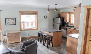 a kitchen with a counter and a table with chairs at Legacy Vacation Rental in Valemount